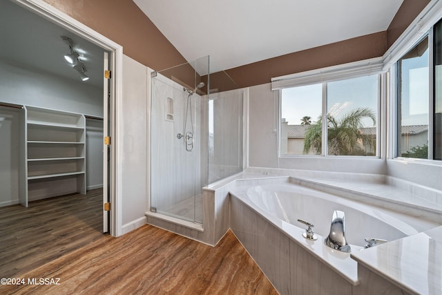 bathroom with hardwood / wood-style flooring and separate shower and tub