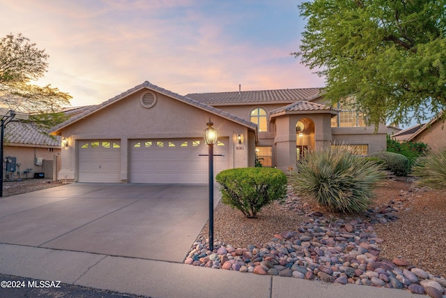 mediterranean / spanish-style house featuring a garage