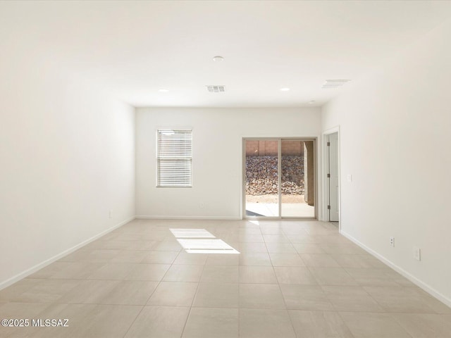 7005 W Jadewood Ln W, Tucson, AZ 85757 - spare room featuring light tile patterned floors, visible vents, and baseboards