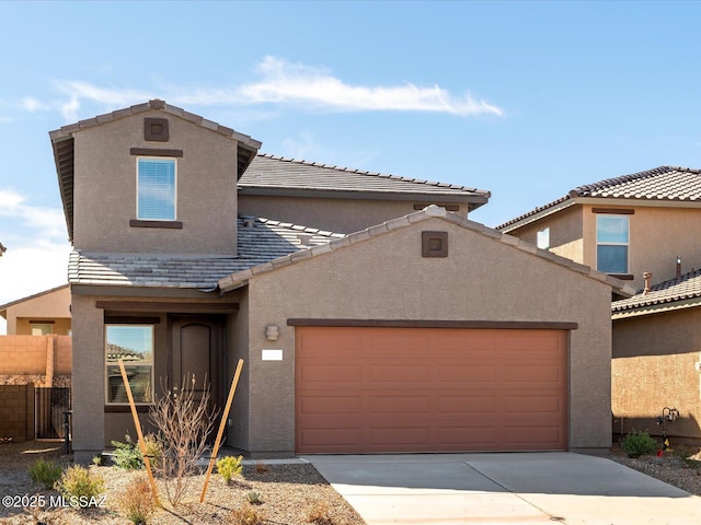 view of front of house with a garage, concrete driveway, a tile roof, fence, and stucco siding