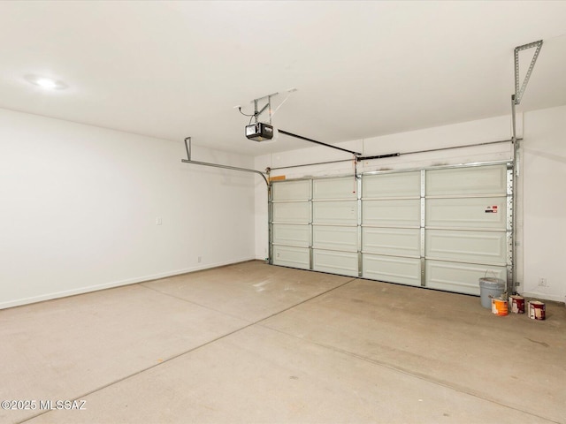 7005 W Jadewood Ln W, Tucson, AZ 85757 - garage with a garage door opener and baseboards