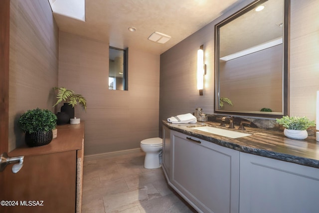 bathroom with toilet and vanity