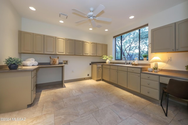 kitchen featuring ceiling fan and sink