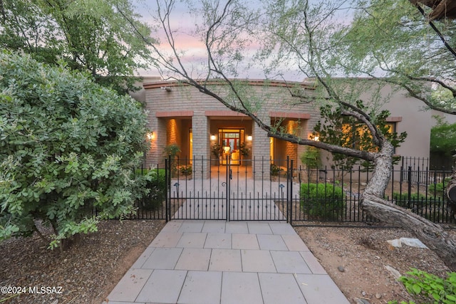 view of gate at dusk