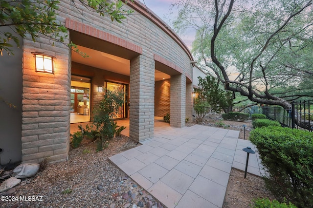 view of patio terrace at dusk