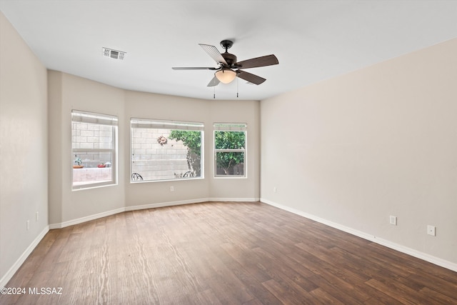 unfurnished room featuring ceiling fan and dark hardwood / wood-style floors