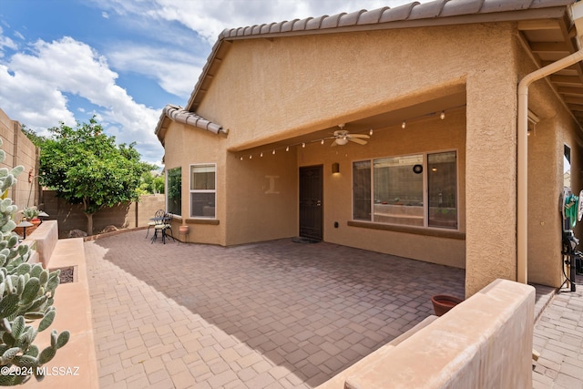 back of house featuring ceiling fan and a patio area