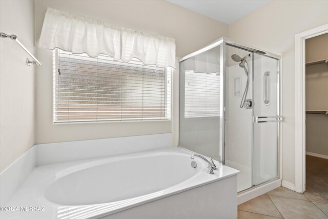 bathroom featuring tile patterned flooring and independent shower and bath