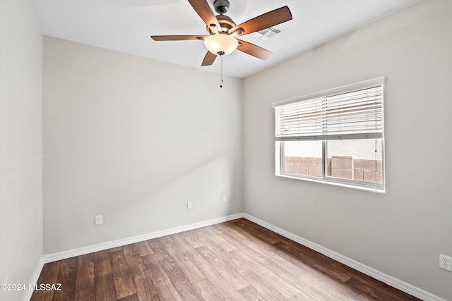 empty room with hardwood / wood-style floors and ceiling fan