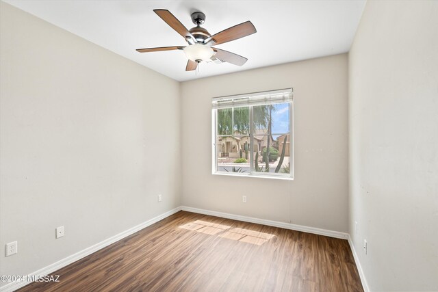 unfurnished room with ceiling fan and dark hardwood / wood-style floors