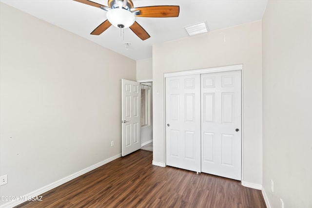 unfurnished bedroom with ceiling fan, a closet, and dark hardwood / wood-style flooring