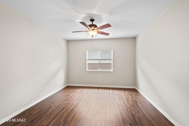 empty room with ceiling fan and dark hardwood / wood-style flooring