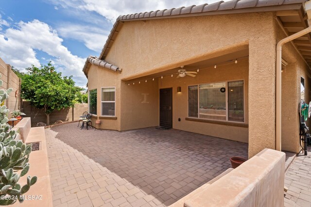 back of property featuring a patio and ceiling fan