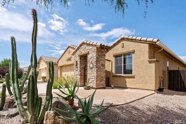 rear view of property with a garage