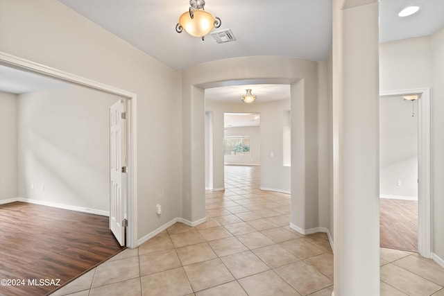 hall with light tile patterned floors