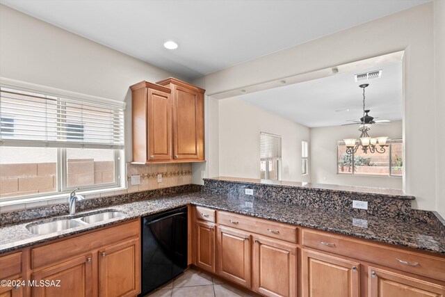 kitchen with black dishwasher, a wealth of natural light, sink, and light tile patterned flooring