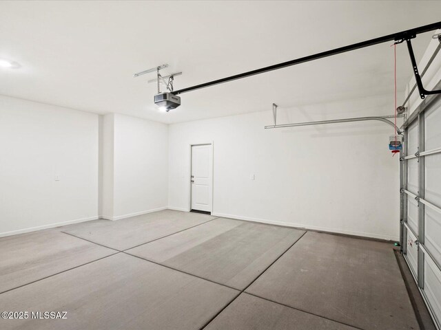 garage featuring baseboards and a garage door opener