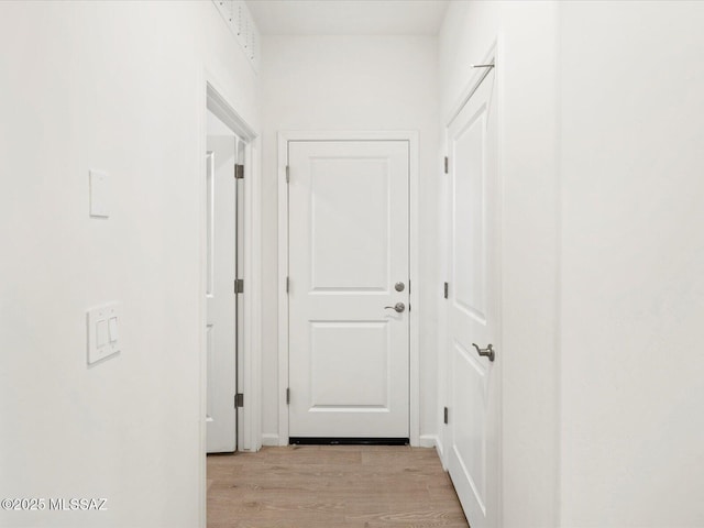 corridor with light wood-type flooring