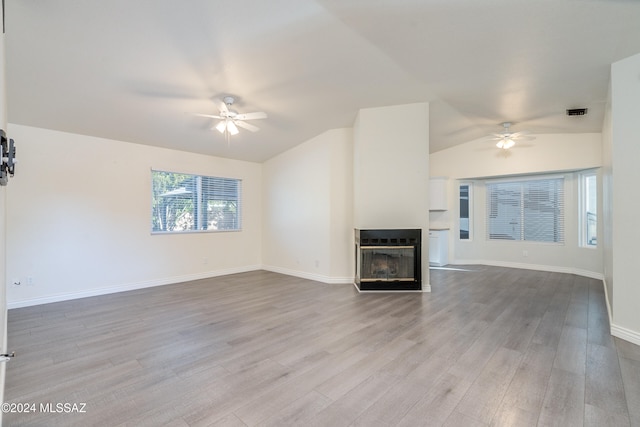 unfurnished living room featuring light hardwood / wood-style floors, lofted ceiling, and ceiling fan