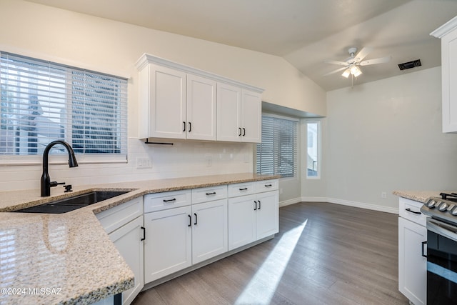 kitchen featuring ceiling fan, white cabinets, and tasteful backsplash