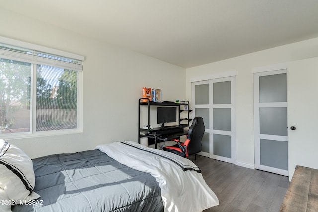 bedroom with dark hardwood / wood-style floors