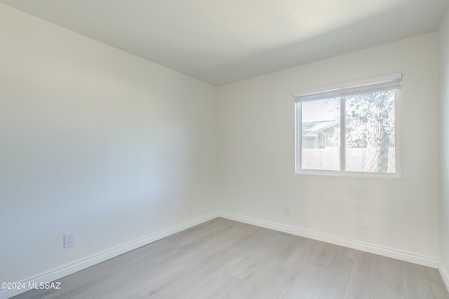 spare room with light hardwood / wood-style flooring