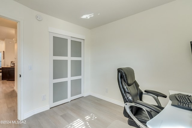 office with light hardwood / wood-style floors