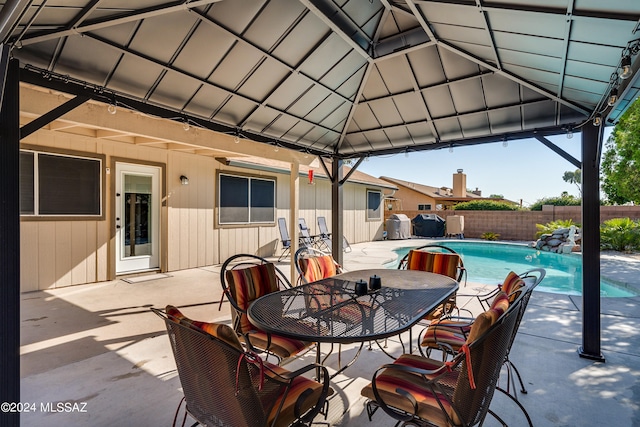 view of patio featuring a gazebo and a fenced in pool