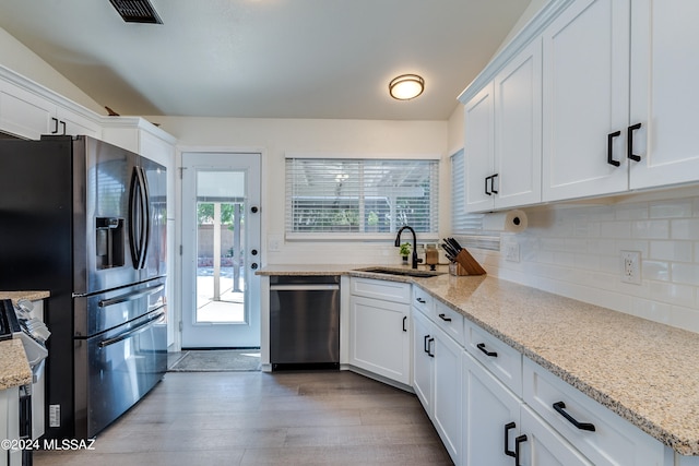 kitchen with white cabinets, appliances with stainless steel finishes, and sink