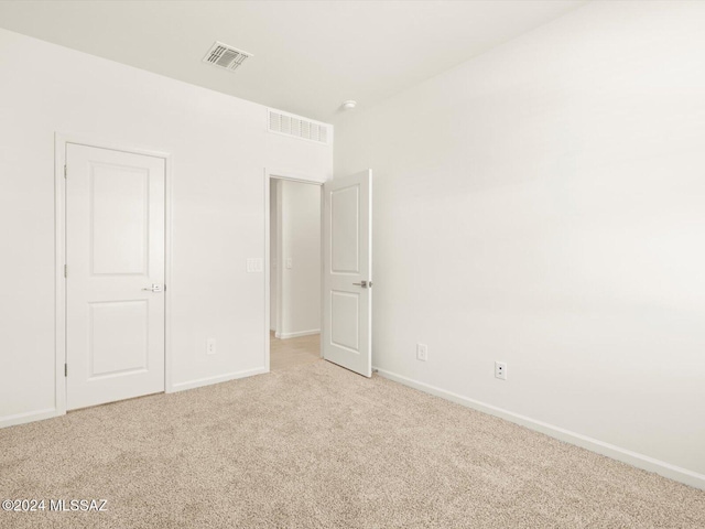 unfurnished bedroom featuring light colored carpet