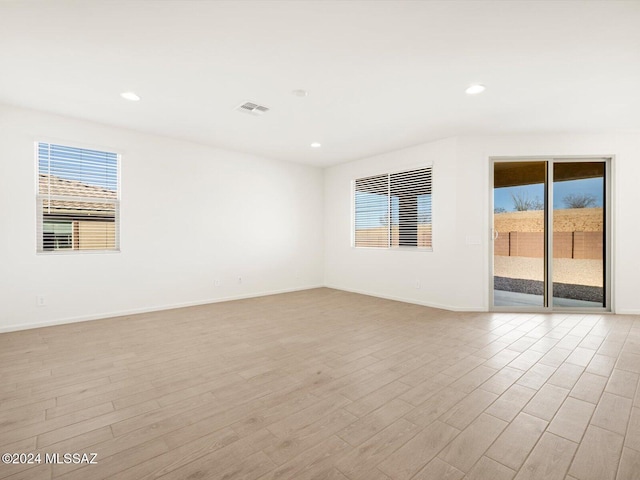 spare room featuring light hardwood / wood-style flooring