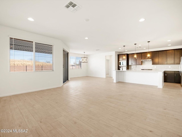 unfurnished living room with light hardwood / wood-style floors