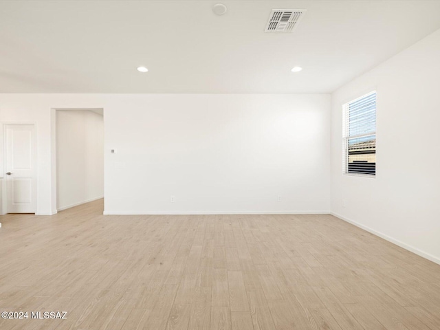 empty room with light hardwood / wood-style flooring