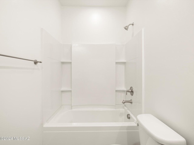 bathroom featuring washtub / shower combination and toilet