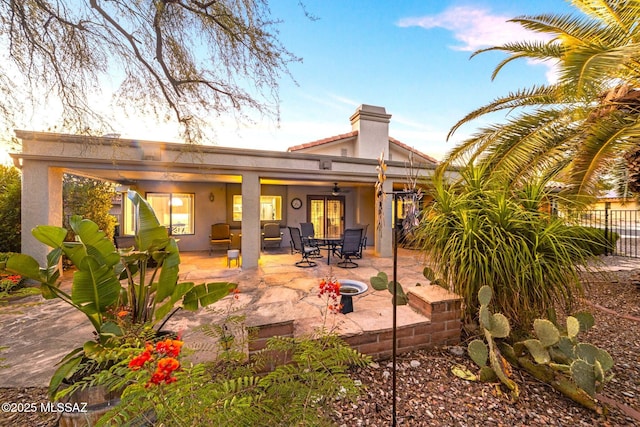 rear view of house with a patio area, ceiling fan, and a fire pit