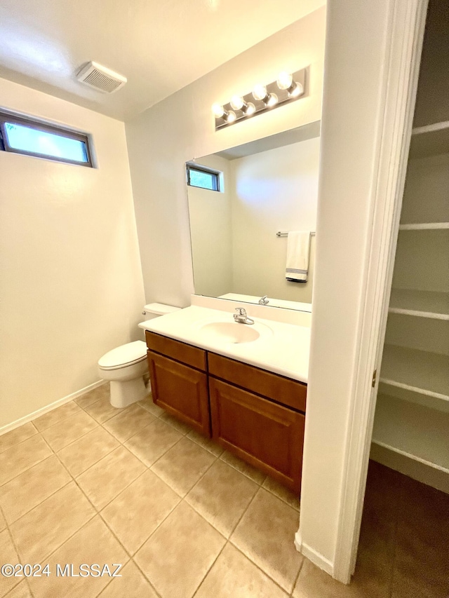 bathroom featuring toilet, tile patterned floors, and vanity