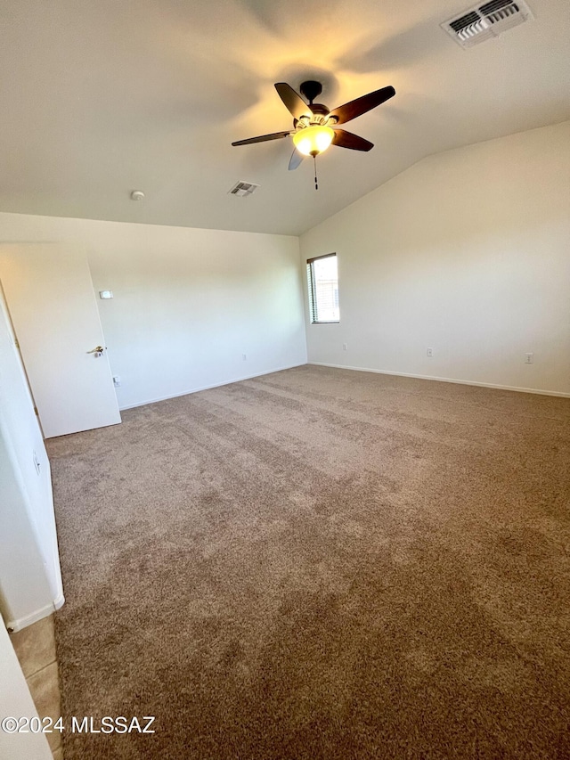 carpeted empty room with ceiling fan and vaulted ceiling