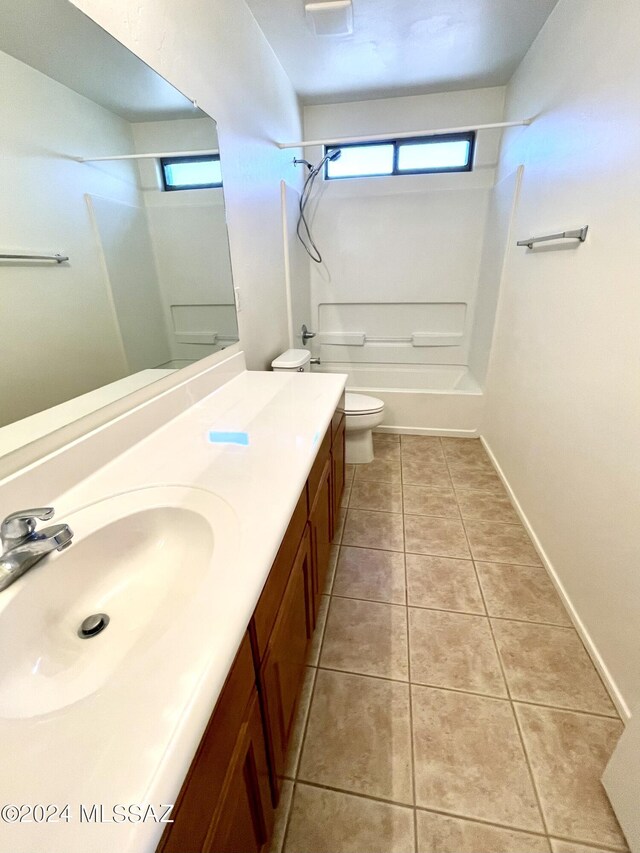 full bathroom featuring toilet, vanity, bathtub / shower combination, and tile patterned floors