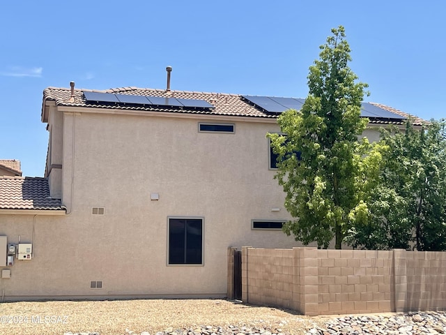 rear view of house with solar panels