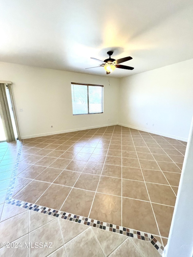 tiled empty room featuring ceiling fan