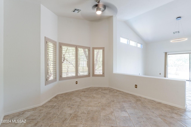 spare room featuring ceiling fan and vaulted ceiling