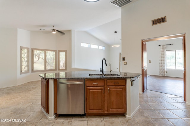 kitchen with dishwasher, pendant lighting, sink, a kitchen island with sink, and light tile patterned floors