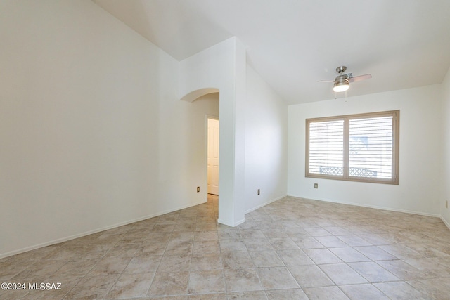 unfurnished room with ceiling fan and lofted ceiling