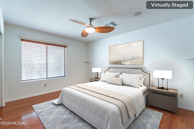 bedroom with ceiling fan and hardwood / wood-style floors