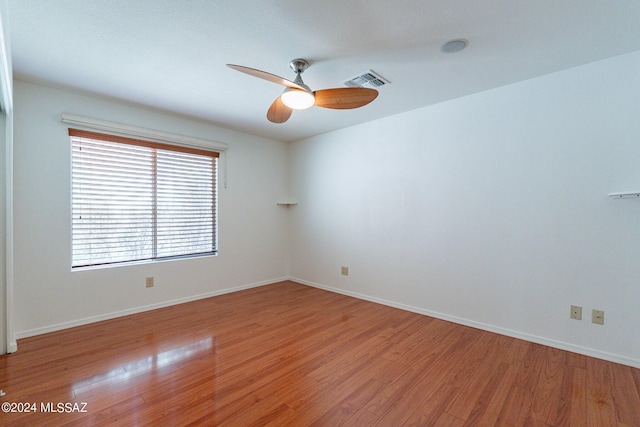 spare room featuring ceiling fan and hardwood / wood-style floors