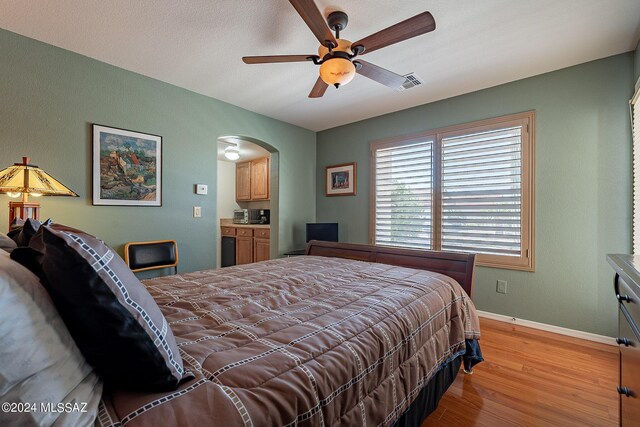 bedroom with ceiling fan and light hardwood / wood-style flooring