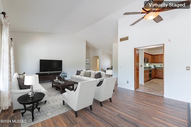 living room featuring ceiling fan, vaulted ceiling, plenty of natural light, and hardwood / wood-style flooring