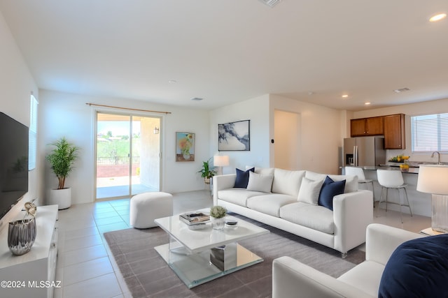 living room featuring sink and dark tile patterned floors