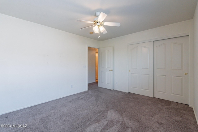 unfurnished bedroom featuring dark carpet, a closet, and ceiling fan