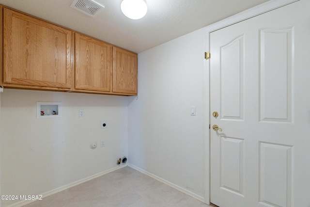 laundry room featuring cabinets, hookup for a washing machine, hookup for an electric dryer, and hookup for a gas dryer